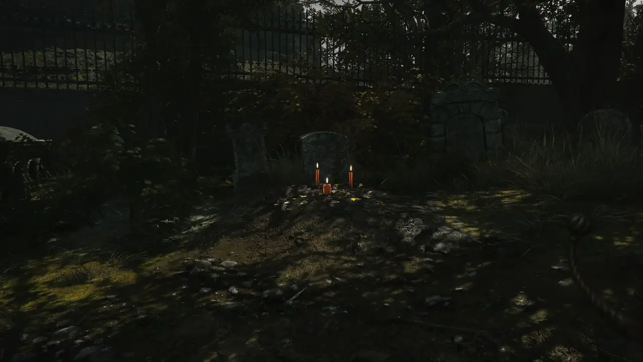 Candles and flowers at the grave where the Red Ribbon is collected