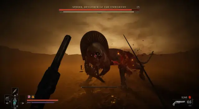 Sphinx stands in the ochre desert boss arena, with its headdress and skull face visible.